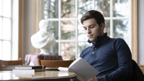 A business student in the library reading