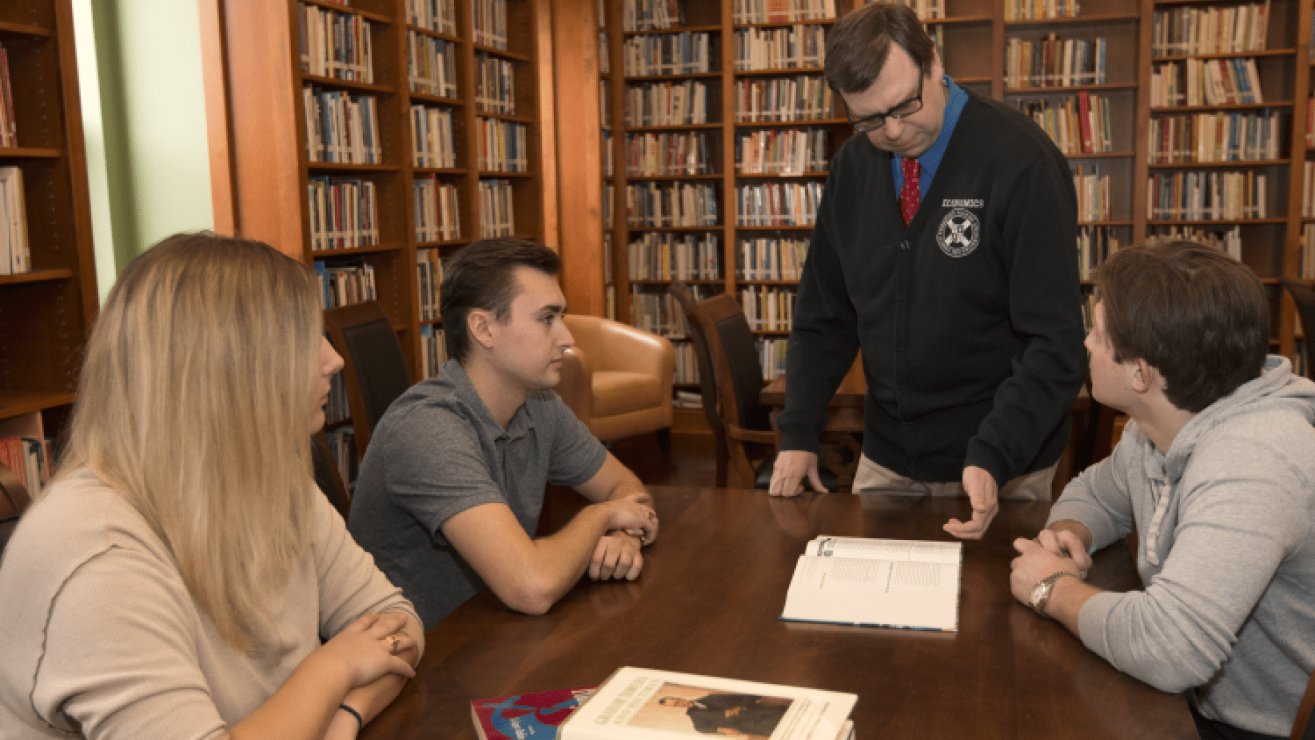 Students and their professor at a table