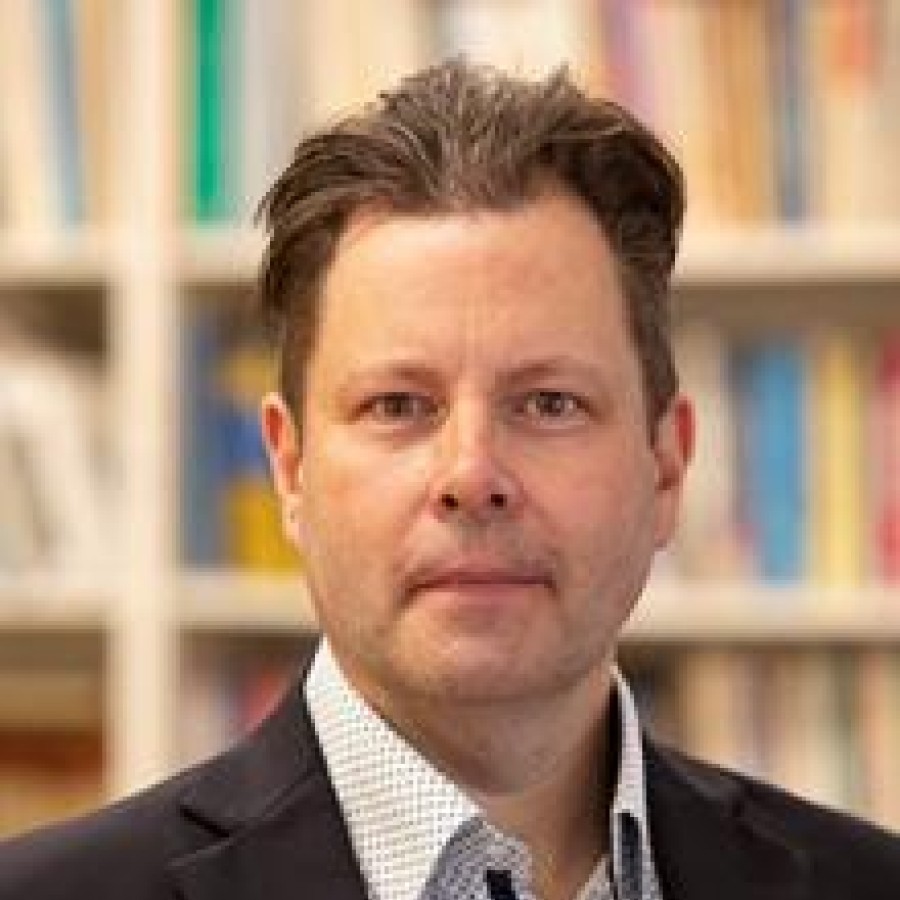 Headshot of man smiling.