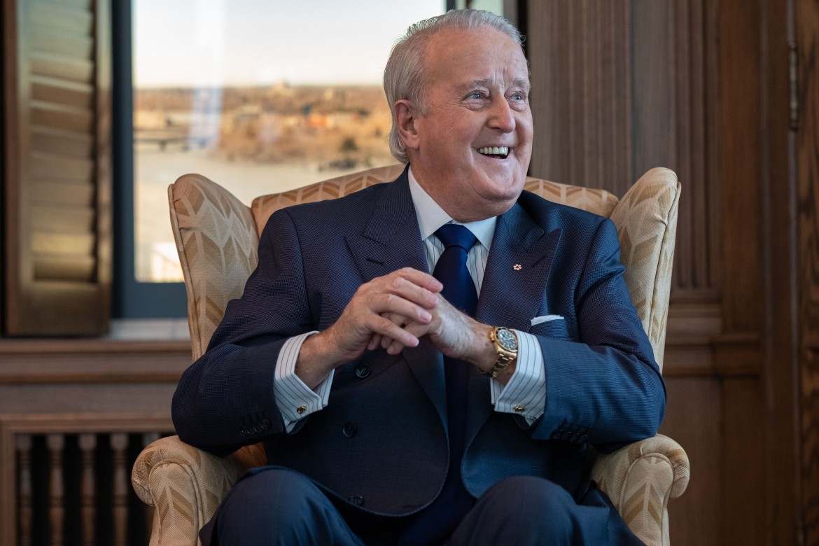 Brian Mulroney sitting in his PMO replica office