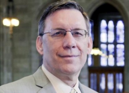 Headshot of a man wearing glasses