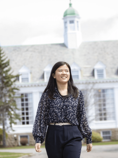 A student in front of Morrison Hall