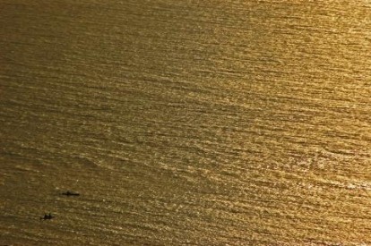 zoomed out picture of a boat in the ocean