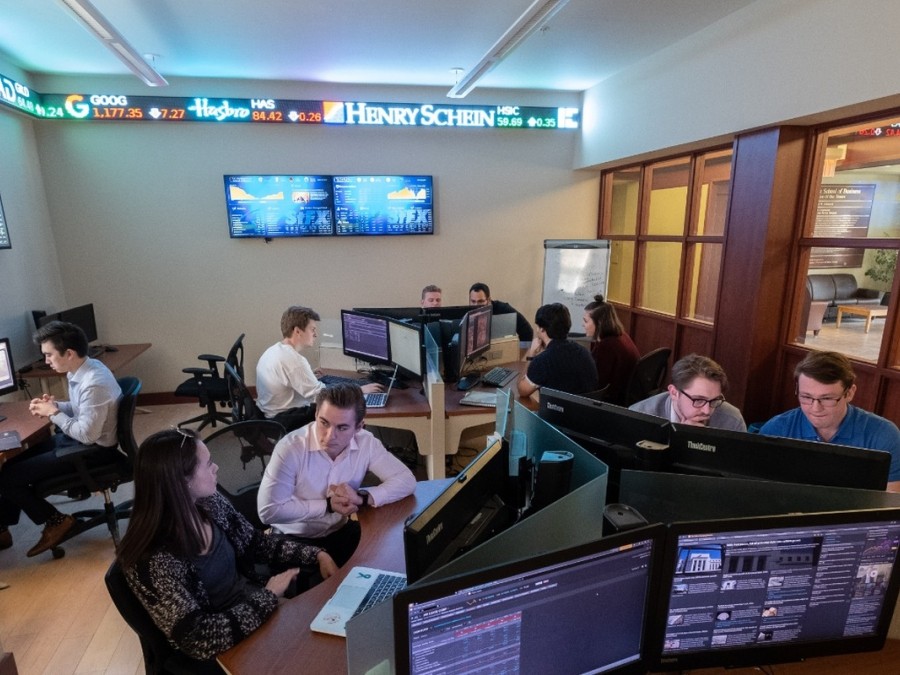Business students studying in the trading room in the Gerald Schwartz School of Business.