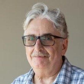 Headshot of man smiling.