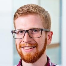 Headshot of man smiling.