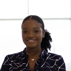 Smiling young black woman with hair tied back